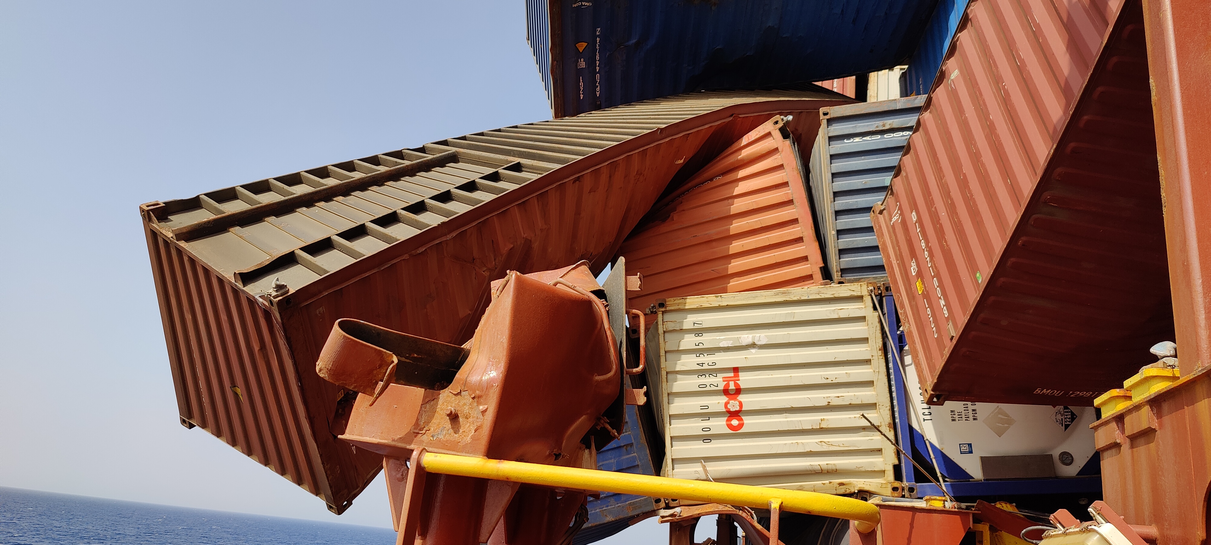 Shipping containers which have been partially crushed. 
